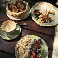 Top: basket of fresh bread, pancakes with fruit and syrup
Middle: cappuccino with soy milk
Bottom: açai bowl at Max Pett in Munich