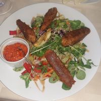 Vegan cevapcici with mixed green salad and ajvar at Kapos Restaurant in Kaposvar