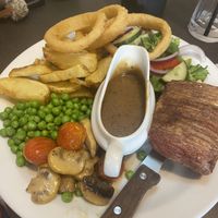 Steak with peppercorn sauce, chips, onion rings and salad  at The Queen Inn in Cwmbran