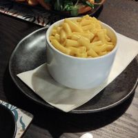 Mac and cheese side with wifes QFC burger in background. at The Queen Inn in Cwmbran