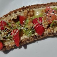 Avocado hummus toast with walnuts and strawberries at Enxalao in San Sebastian