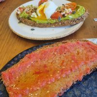 Tomato & oil on toast (minus chunk I ate!), with avocado and poached egg in background at Enxalao in San Sebastian