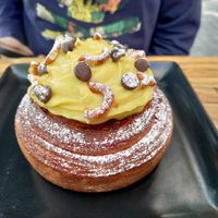 Cinnamon pastry topped with cream at Miga Vegana in Mexico City