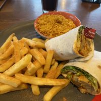 Great imitator chicken wrap with sides: spicy rice and seasoned fries   at Nando's in Londonderry
