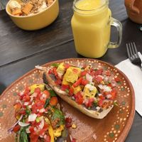 Smoothie de mango y plato de fruta  at NorthSide Cafe in Sayulita