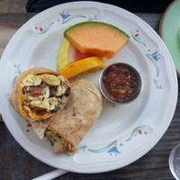 Breakfast burrito with veggie bacon, salsa, and fruit.  at The Den Cafe in Costa Mesa