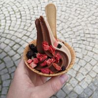 Small cup with natural and chocolate flavour side by side with dried blueberries and strawberries on top at Keep Bañana in Munich