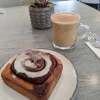Vegan cinnamon roll and dirty chai with oat milk at Trellis Coffee Shop in Ellon