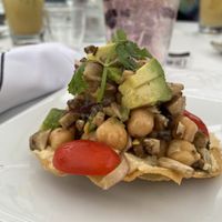 Taco appetizer with hummus, chickpeas, mushrooms, tomatoes, avocados and red onion  at Stones Throw in York
