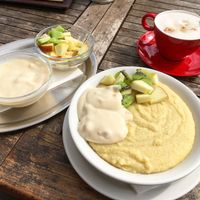 Millet porridge with soy yogurt and fruit + cappuccino  at Altes Feuerwehrhaus in Damshagen