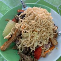 Ramen noodles on top of soy chicken, pork and rice at Jay Tamachad in Koh Samui