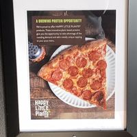 Article inside restaurant regarding plant based (vegan) meat option at University Pizza Company in Riverside