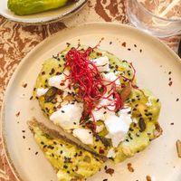 avo toast with 🌱 feta, almonds, pumpkin & sesame seeds  at Nowhere in Milan