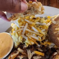 Berkeley Biscuit Sandwich (biscuit sandwich with Beyond vegan sausage, vegan cheese, and Just Egg), and a side of hashbrowns at Seven Mile Cafe in Lewisville