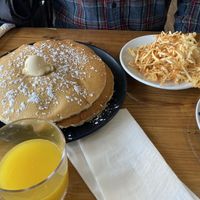 Fresh squeezed OJ, plain vegan pancakes, and crispy hash browns  at Seven Mile Cafe in Lewisville