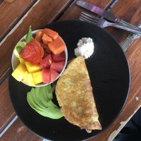 Vegan chickpea omelette with cashew cream and fresh fruit at Noi Bistro in Tamarindo