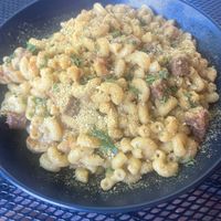 Mac and cheese with beyond sausage addition. A “nooch” forward Mac and cheese with a coconut cream base. Good but could be creamier, at Vegan Street in Calgary