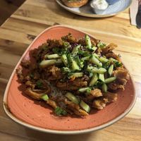 Ginger beef (appetiser but with the jasmine rice add on) chicken burger in backround  at Vegan Street in Calgary