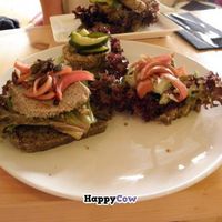 Smorrebrod Plate with three types of smorrebrod(left-right):

Portobello paté with pickled red onions, lentilburger with pickles and parsleycreme with pickled red onions.  at simpleRaw - Oehlenschlaegersgade in Copenhagen
