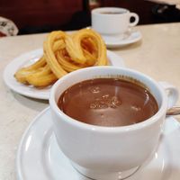 Hot chocolate with fresh, crispy churros at Chocolateria 1902 in Madrid