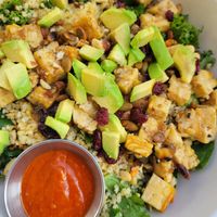 Cali Tempeh power bowl with red dressing on the side at Veggie Grill by Next Level in Santa Monica