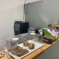 Green Heart Collective cafe counter with baked goods and snacks and coffee machine at Green Heart Collective in Gateshead