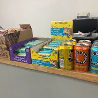 Vegan snack bars and cans of pop on Green Heart Collective cafe counter at Green Heart Collective in Gateshead