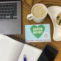 Flat lay of Green Heart Collective cafe seating area with coffee and vegan blueberry muffin at Green Heart Collective in Gateshead