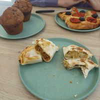 Banana and chocolate muffins, cheese and onion empanada, soya mince empanada, tomato and olive foccacia at Isla Vegana in Ushuaia