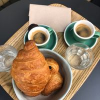 (2) Petit-déjeuner menues = Espresso + croissant/pain au chocolat. 
Mini financier next to the left espresso at Land & Monkeys - Turenne in Paris