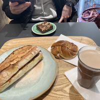 Mediterranean baguette, cinnamon roll, oat milk hot choc and brownie 🥹  at Land & Monkeys - Turenne in Paris
