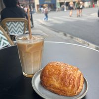 Iced latte and pain au chocolat watching the city go by. at Land & Monkeys - Turenne in Paris
