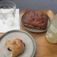 Olive bread, chocolate chip donut with lemon ginger juice at Land & Monkeys - Turenne in Paris