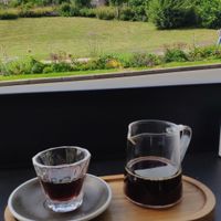 Slow coffee with the castle in the background at Arbuste in Caen