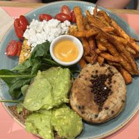 Vegan brunch plate: chickpea omelette, vegan feta cheese and cherry tomatoes / avocado toast and sweet potato fries with harissa mayo / vegan chocolate chip and banana pancakes  at Shake Café in Florence