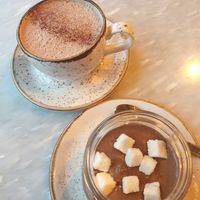 Hot chocolate with cinnamon and overnight oats with cacao, coffee and coconut. at FINT Kafé & Bar in Tromsoe