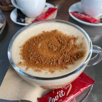 Chai Latte with oat milk. Dark chocolate and peanut butter crunch in the background.  at Delikat  in Viersen