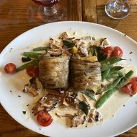 Roasted eggplant with polenta, chanterelle mushrooms, tomatoes, snap peas, sage, and vegan cream sauce  at Mountain Brauhaus in Gardiner