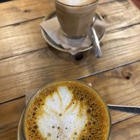 Latte and a turmeric latte. While we wait for cake😊  at Wild Root in Southport