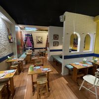 The second room with a special place to the right with a round table  at Panchito in Barcelona