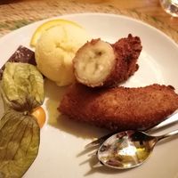 Dessert of fried banana, home made passionfruit sorbet, dark chocolate and fruit at Four Roses in Groningen
