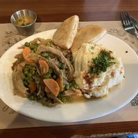 Not pollo arvejado, puré de papas, sopaipillas con pebre.    at Enki in Valdivia