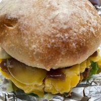 Burger close up, loaded with vegan cheese. at Roddy Burger in Tunbridge Wells