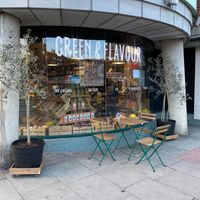 Exterior of shop and outside seating at Green & Flavour in North London