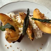 Crostini w whipped ricotta, peaches - vegan version.   at Gia in Toronto