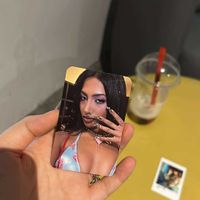 Photo cards and a mango tea (mostly gone) in the back  at Fam Kpop and Bubble Tea in Sofia