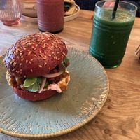 Cauliflower katsu burger on beetroot bread (sweeter than normal bread) with a super green smoothie.  Also a mixed berry smoothie in the background. at Out-there Artisan in Jedburgh
