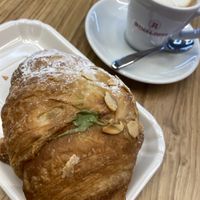 Pistacchio cream filled croissant and oat milk macchiato  at FCO - Natoo in Fiumicino