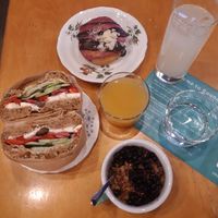 Brunch with olive feta bagel, lemonade and blueberry-chocolate donut, juice and granola bowl. at ROUND - Helsinginkatu in Helsinki