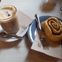 Coffee with soy milk and cinnamon roll at La Tribu - Pastelería Vegana in Barcelona